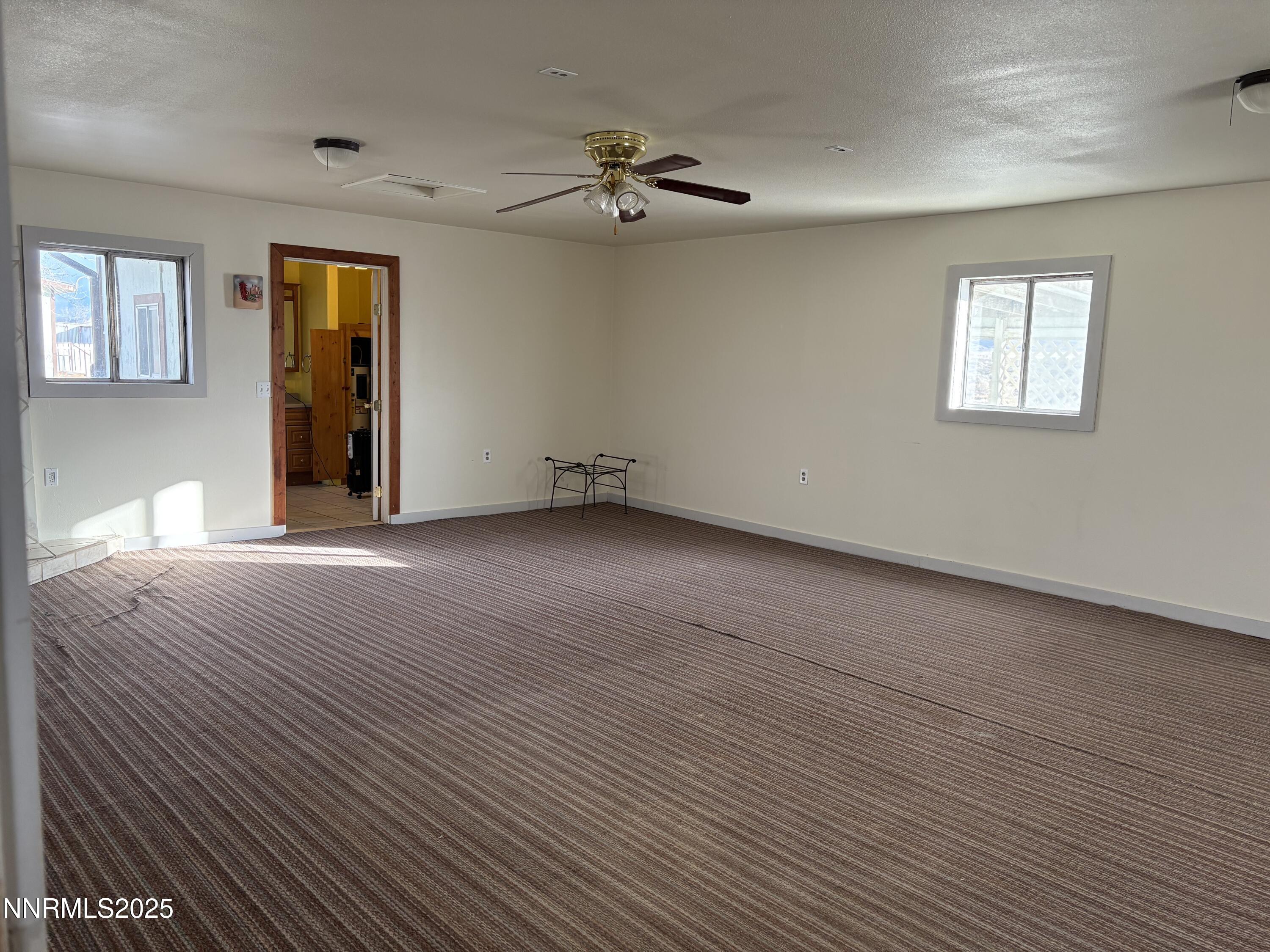 20 Miley Lane Yerington, NV 89447 - Photo 17 of 29 a view of an empty room with wooden floor and a window