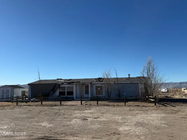 a view of a house with wooden fence
