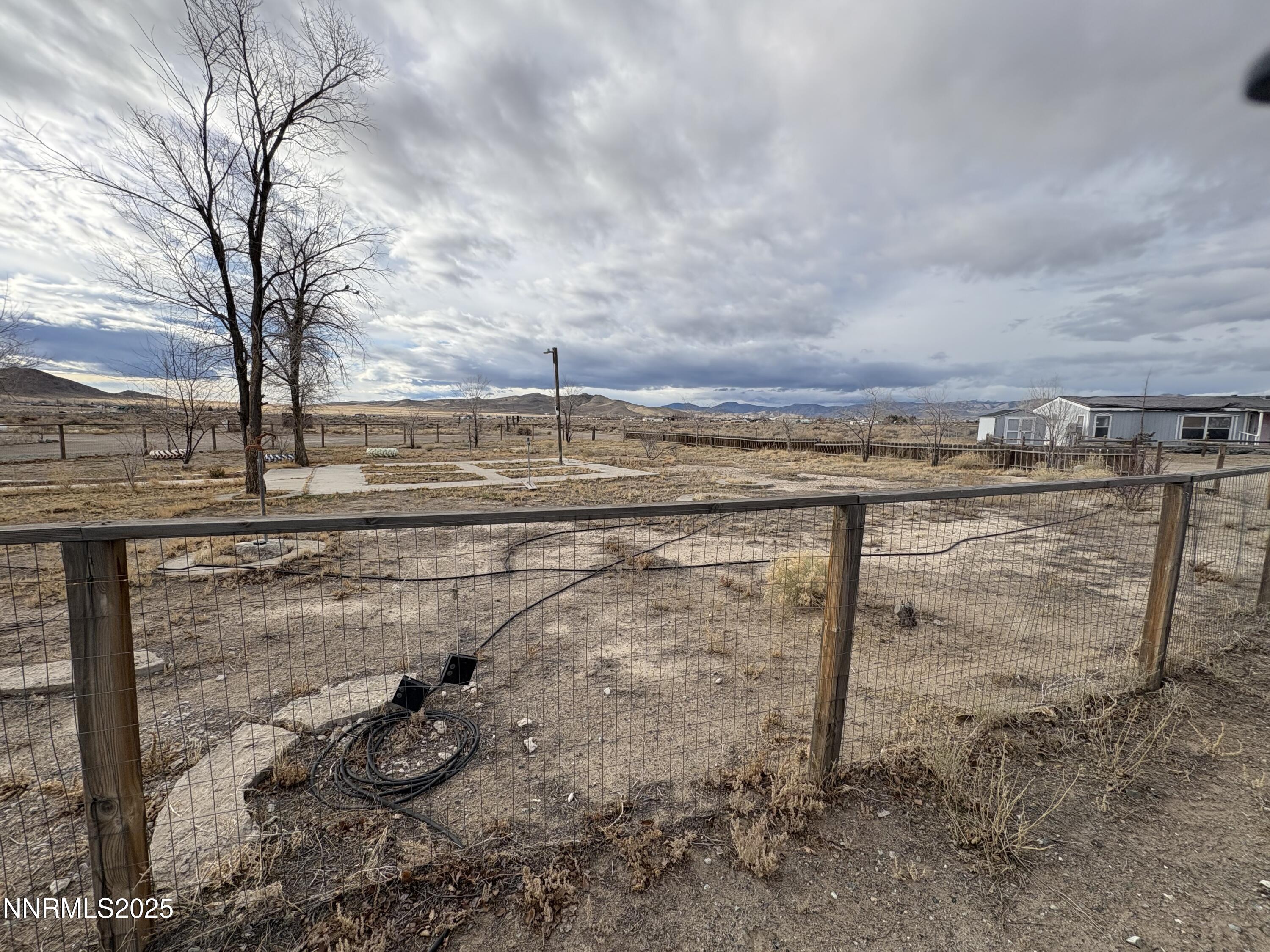 20 Miley Lane Yerington, NV 89447 - Photo 5 of 29 a view of a dry yard with wooden fence