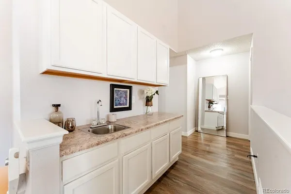 a hallway with sink and mirror