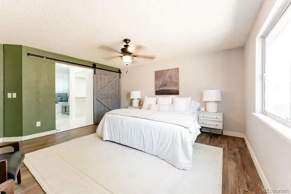 a bedroom with a large bed and a window
