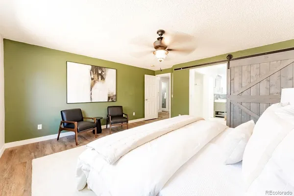 a bedroom with a bed a table and chair