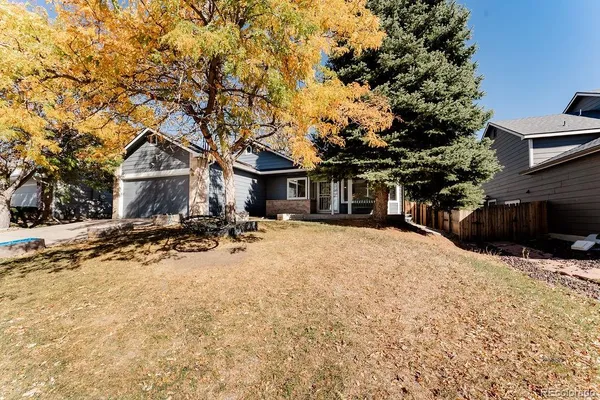 a front view of a house with a yard covered with snow