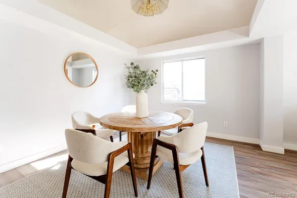 a view of a dining room with furniture and wooden floor