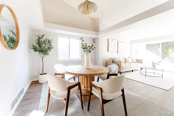 a view of a dining room with furniture and a potted plant