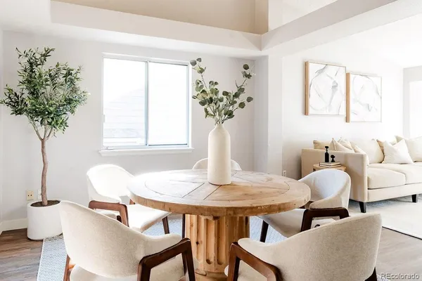 a dining room with furniture and wooden floor