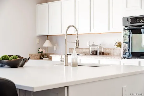 a kitchen with a sink a counter and appliances