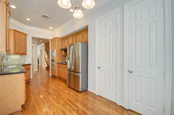 a view of a hallway with wooden floor and entryway