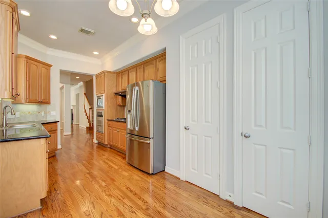 a view of a hallway with wooden floor and entryway