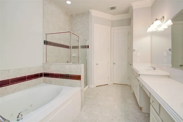 a bathroom with a double vanity sink mirror and shower