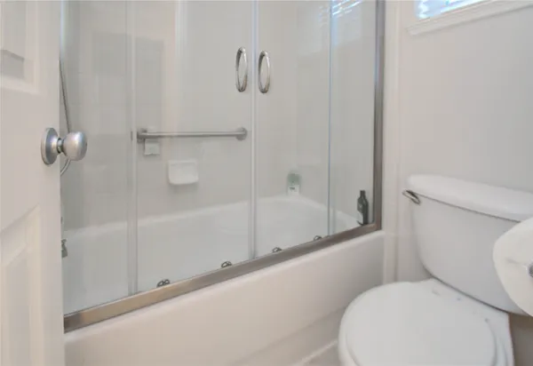 a view of a brick house with a door and wooden walls