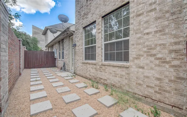 a backyard of a house with potted plants