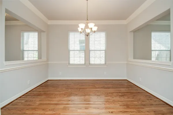 a view of an entryway with wooden floor and livingroom view