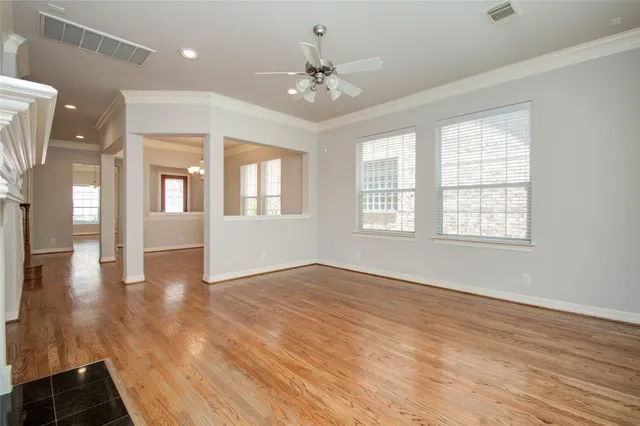 wooden floor in an empty room with a window
