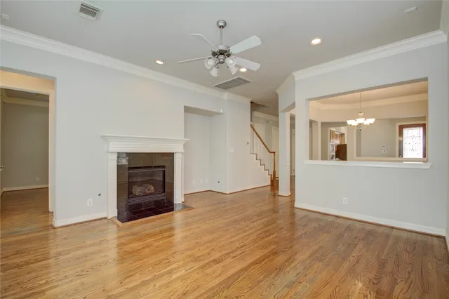 a kitchen with stainless steel appliances granite countertop refrigerator sink and wooden floor