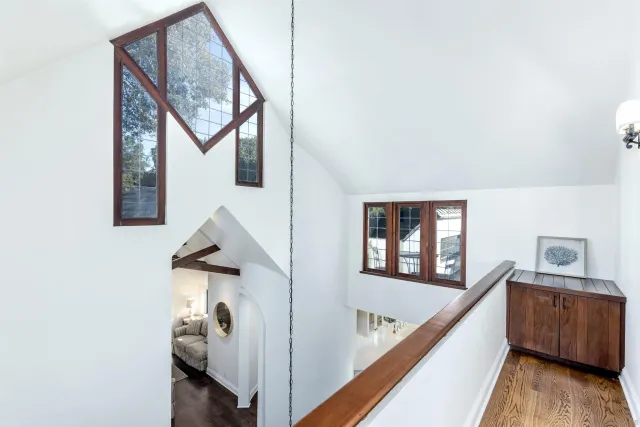 a view of hallway with stairs and wooden floor