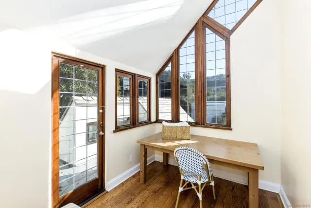 a balcony with table and chairs