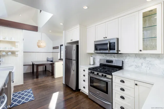 a kitchen with stainless steel appliances a refrigerator a stove microwave and cabinets