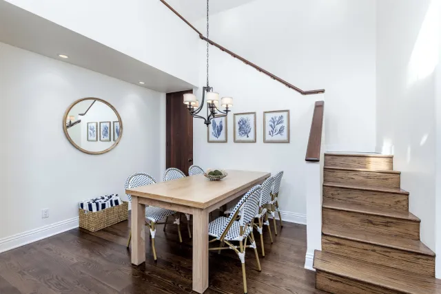 a view of a dining room with furniture and a mirror