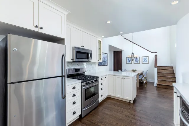 a kitchen with stainless steel appliances a refrigerator stove and microwave