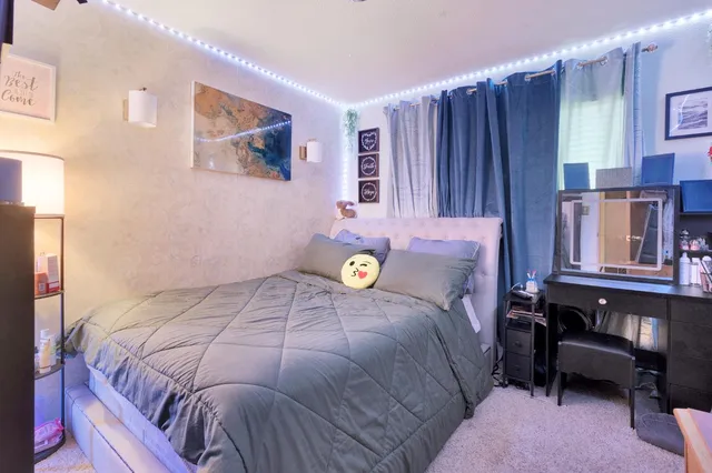 a bedroom with bed couch and window