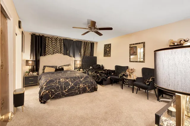 a view of a hallway with workspace and living room