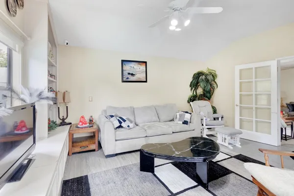 a living room with furniture and a chandelier