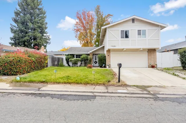 a front view of a house with a yard and garage