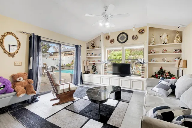 a view of a patio with dining table and chairs with wooden fence