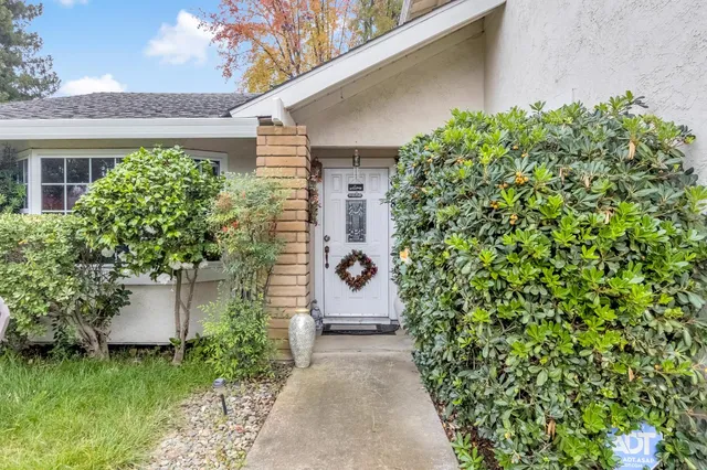 a front view of a house with a garden