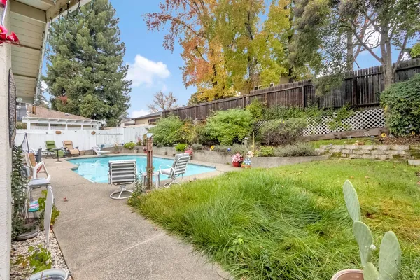 a front view of a house with swimming pool and porch