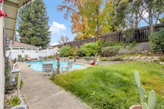 a front view of a house with swimming pool and porch