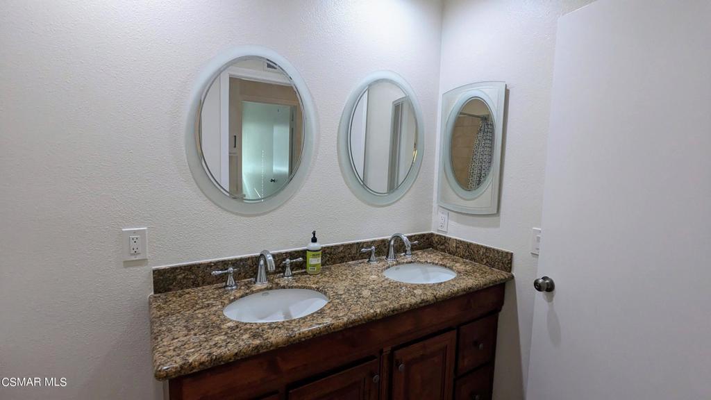 2501 Radford Court Simi Valley, CA 93063 - Photo 14 of 21 a bathroom with a granite countertop double vanity sinks and a mirror