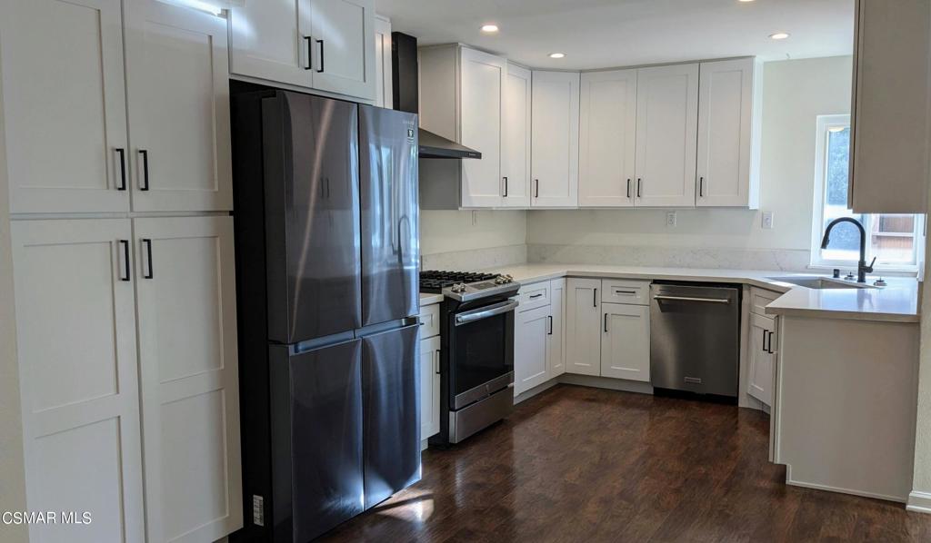 2501 Radford Court Simi Valley, CA 93063 - Photo 8 of 21 a kitchen with a refrigerator sink and cabinets