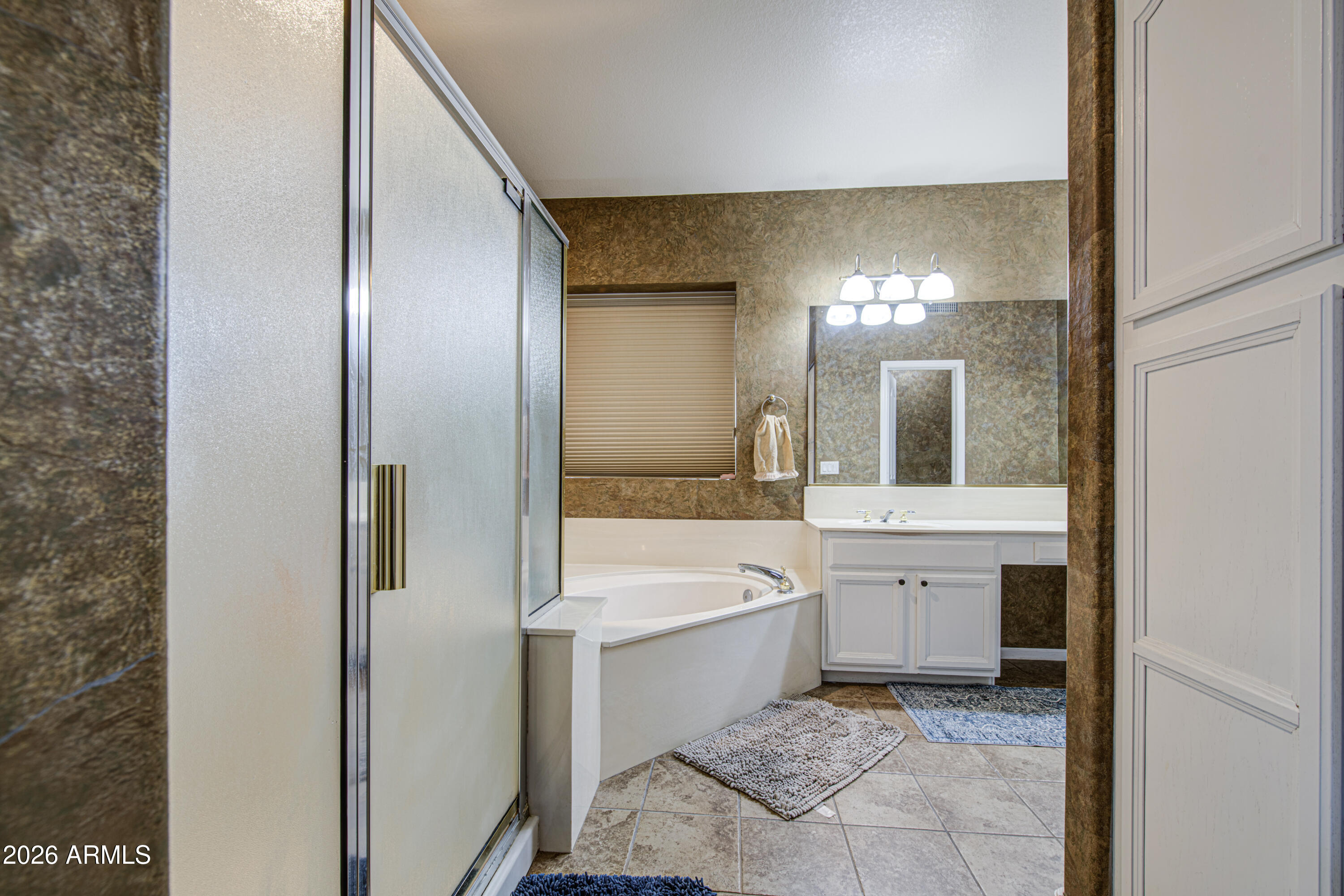 12403 West Monte Vista Road Avondale, AZ 85392 - Photo 33 of 63 a bathroom with a tub sink and mirror