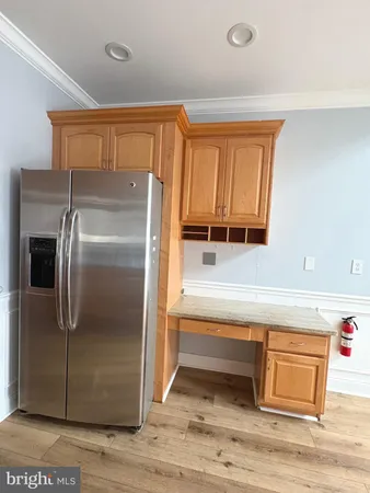 a kitchen with a refrigerator and cabinets