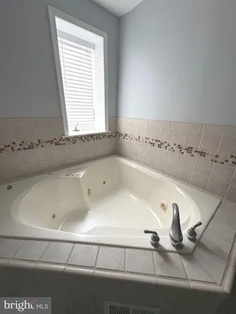 a bath tub sitting next to a window