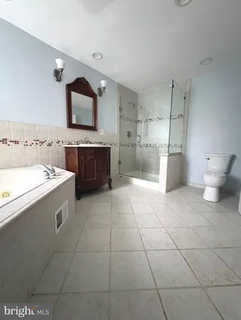 a large white kitchen with a stove a sink dishwasher and a refrigerator