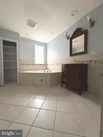 a view with kitchen island sink and refrigerator