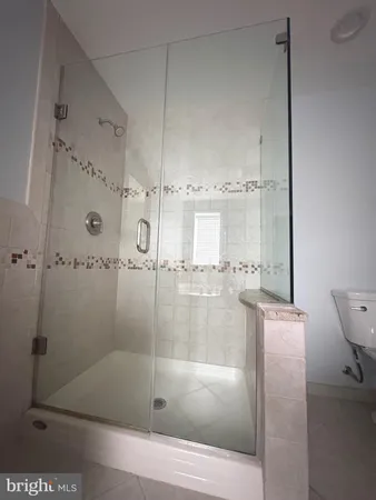 a bathroom with a glass shower door