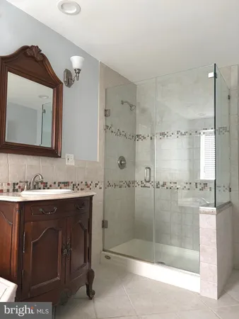 a bathroom with a double vanity sink mirror and shower