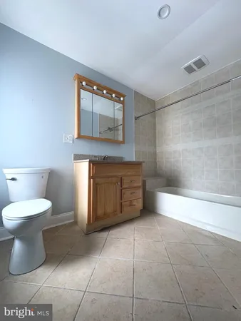 a bathroom with a toilet a sink and a mirror
