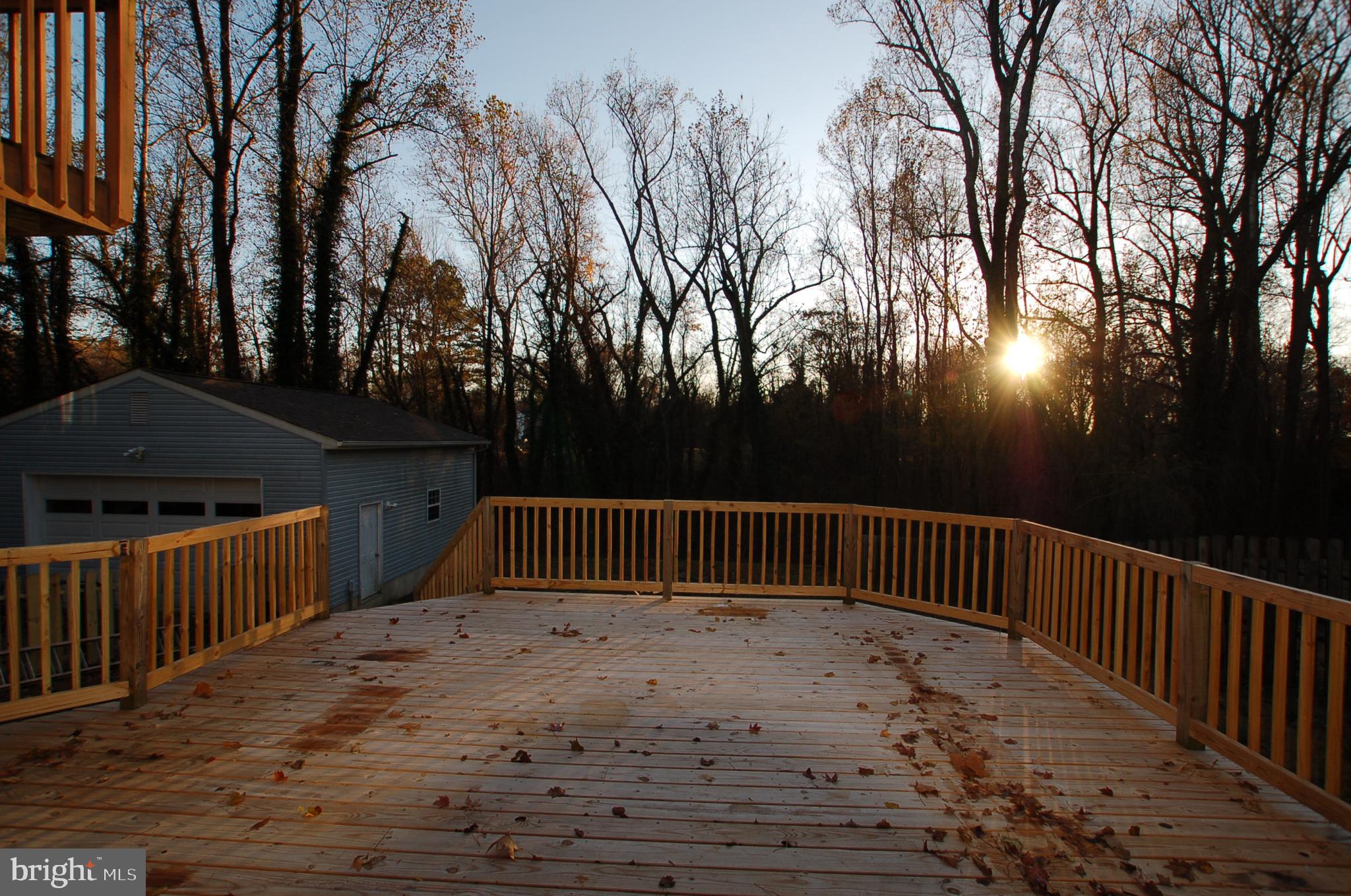 8275 Sycamore Road Lusby, MD 20657 - Photo 18 of 19 Large lower level deck leading to backyard