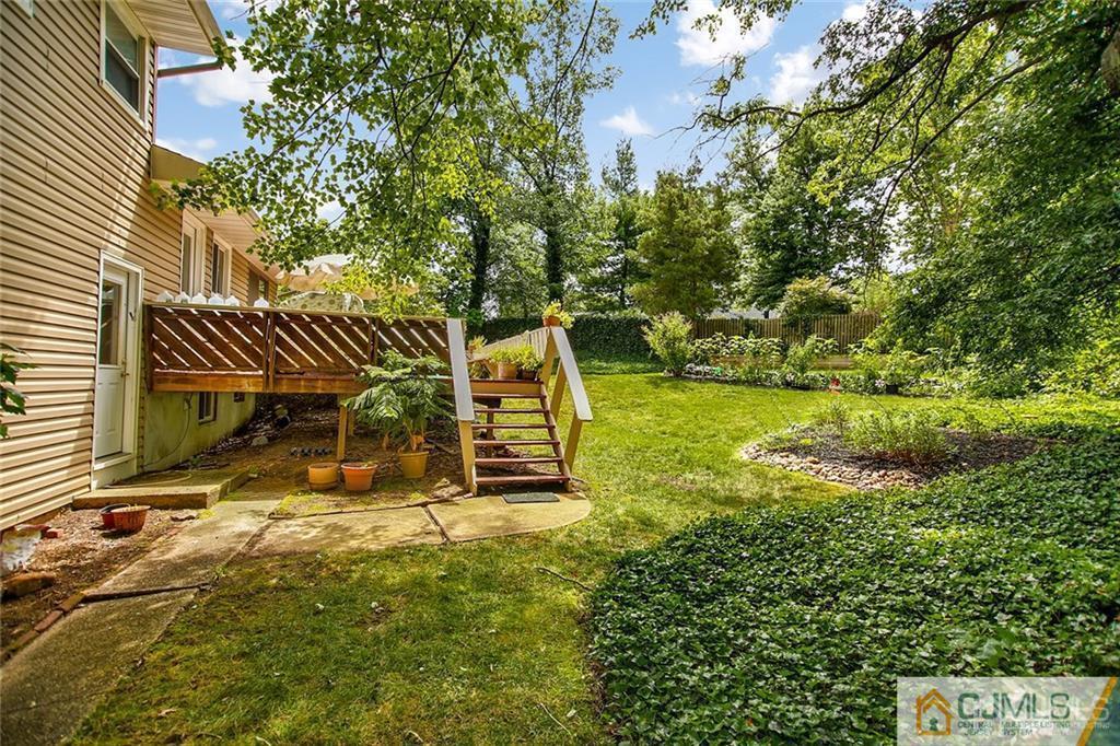 5 Steelox Road East Brunswick, NJ 08816 - Photo 23 of 24 a view of a backyard with table and chairs and potted plants