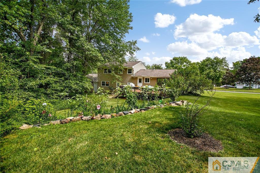 5 Steelox Road East Brunswick, NJ 08816 - Photo 24 of 24 a view of a big yard with flower plants and wooden fence