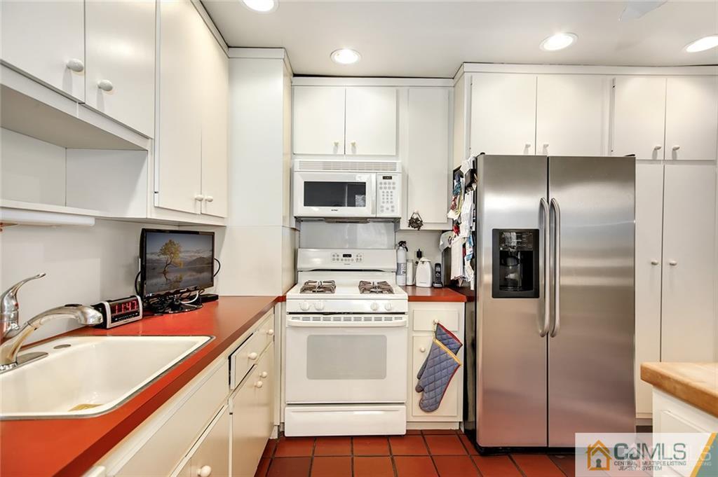 5 Steelox Road East Brunswick, NJ 08816 - Photo 10 of 24 a kitchen with a sink stainless steel appliances and cabinets