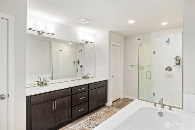 a bathroom with a double vanity sink mirror double and shower