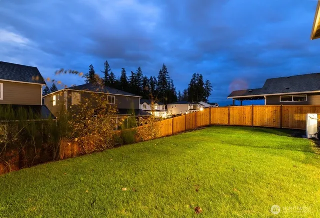 a view of a yard with swimming pool and brick wall