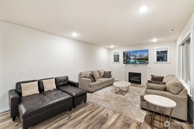 a living room with furniture a fireplace and a view of kitchen