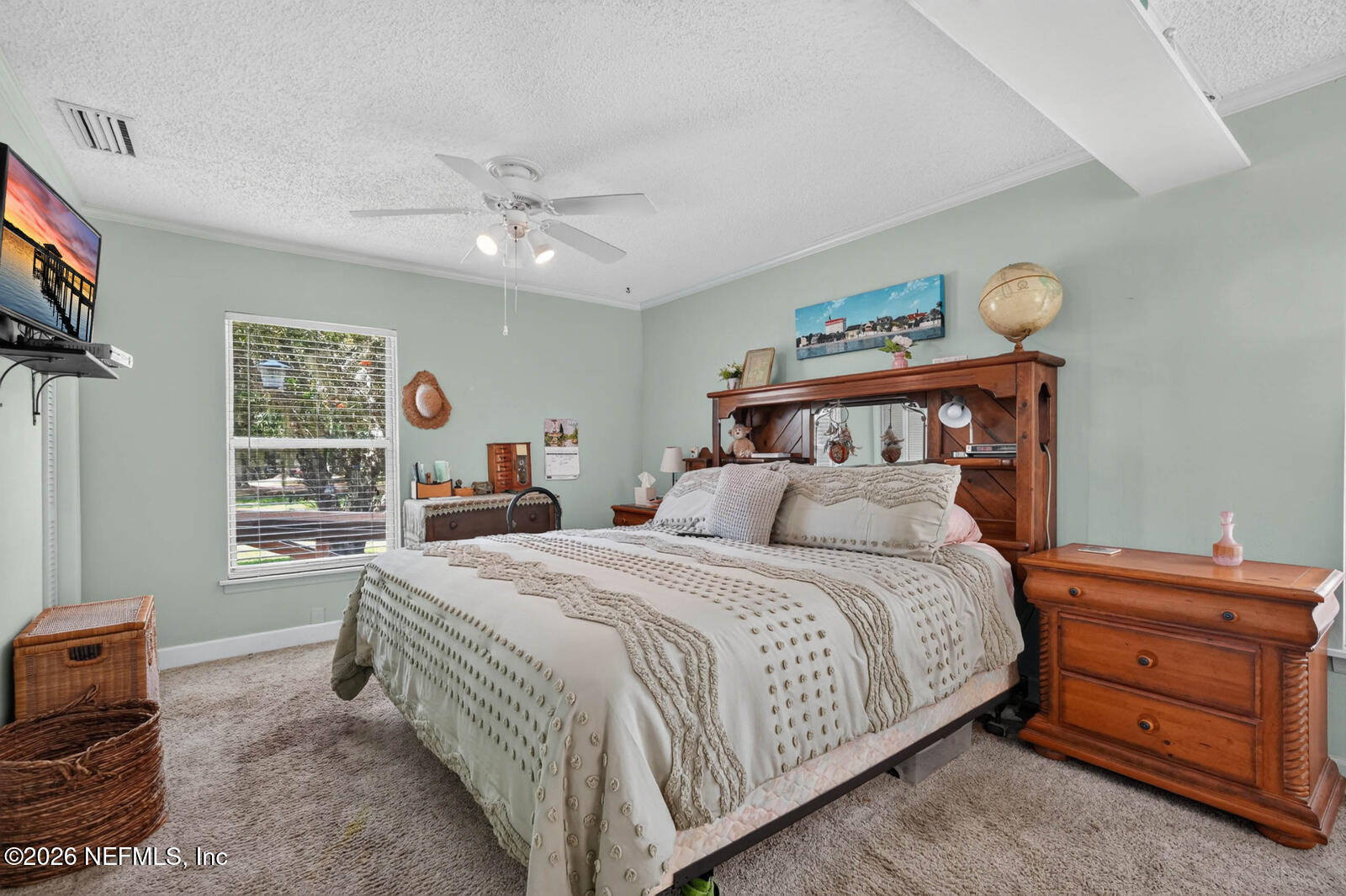 1950 Lightsey Road St. Augustine, FL 32084 - Photo 21 of 57 a bedroom with a bed and a chandelier